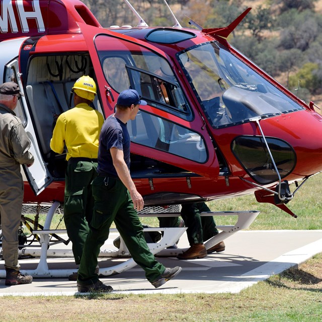 Fire crews prepare a helicopter for response at moments notice. 